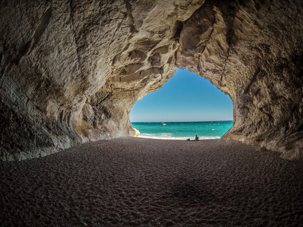 Exit of cave to beach representing exiting a startup.