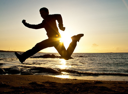man running on beach to represent chasing investors and chasing customers.